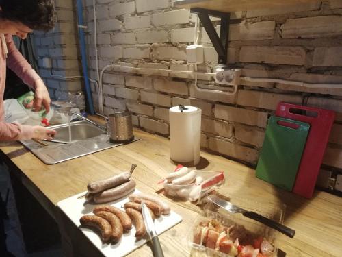 a table with sausages on a cutting board at Siedlisko Bolek in Nadrybie