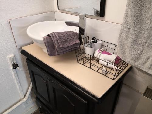 a bathroom vanity with a sink and a mirror at Au QUATRE, 2em étage centre historique in Pézenas