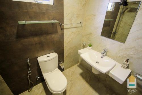 a bathroom with a white toilet and a sink at Airport Green Olive Villa in Katunayaka