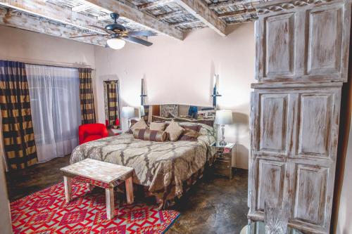 a bedroom with a large bed and a red rug at View Hotel Boutique in San Miguel de Allende