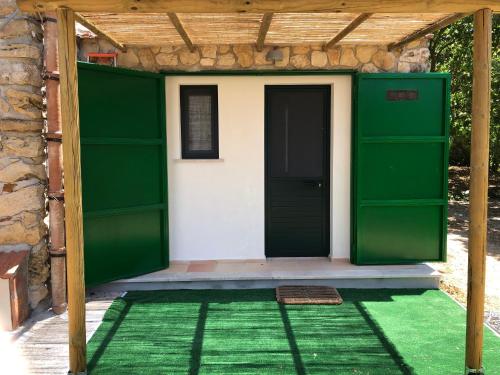 a green entrance to a house with a green door at Egesta, villa with private pool in Calatafimi