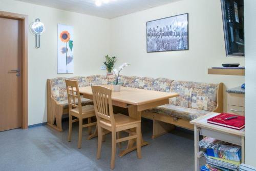 a dining room with a table and a couch at BodenSEE Haus am Geissbock in Meckenbeuren