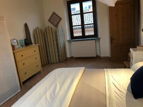 a bedroom with a bed and a window and surfboards at Viaggio della Vita B&B in Fontanile
