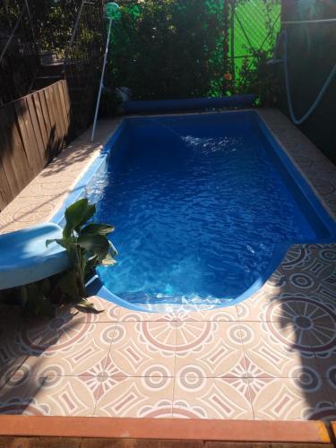 a small blue pool with a tile floor at Hospedaje San Antonio Tepoztlán. in Tepoztlán
