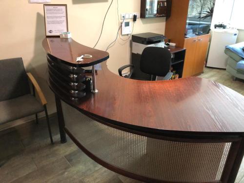 a wooden table with a chair in a room at Hostel Laurita in Kaunas