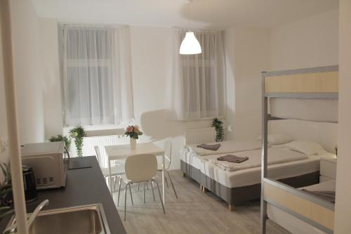 a small room with a bed and a table at Betariel Apartments S32 in Vienna