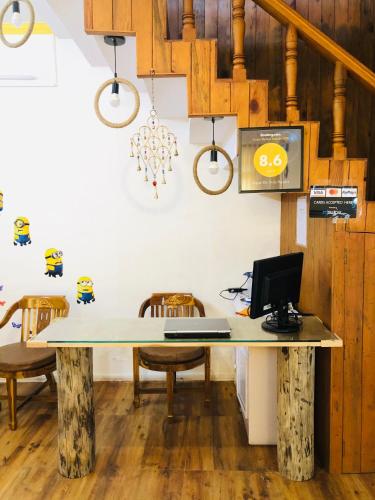 an office with a table with chairs and a laptop at Aqua De Vida in Bhowāli