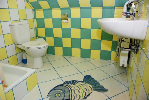 a bathroom with a toilet and a sink at Guest House LT in Kaunas