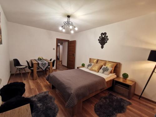 a bedroom with a bed and a dining table at Apartament Krupówki Centrum in Zakopane