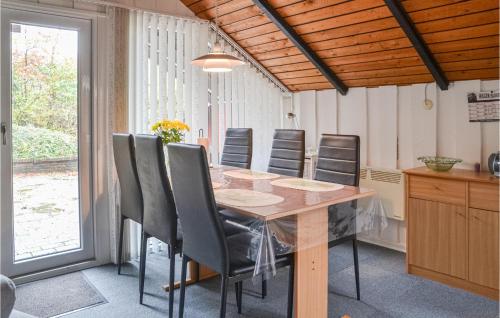 a dining room with a table and chairs at Holiday Home Søknudevej Iv in Ansager