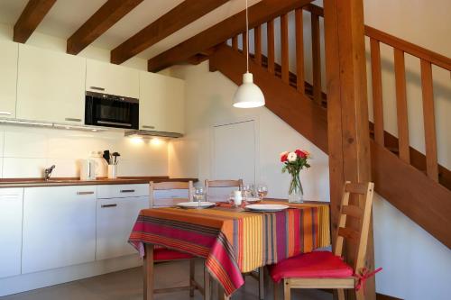 a kitchen with a table with a colorful table cloth at BaskoParadis I Eco-Gites I Calme I Vue I Ânes I Jardin I Montagne I Nature in Louhossoa