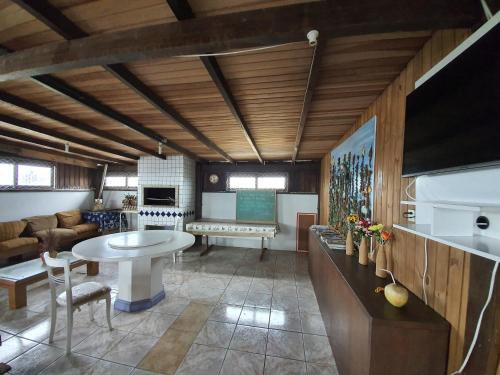 a living room with a table and a couch at Residencial Rei Thomas in Capão da Canoa