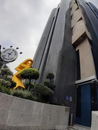 a building with a clock on the side of it at AUTO HOTEL LEGARIA in Mexico City