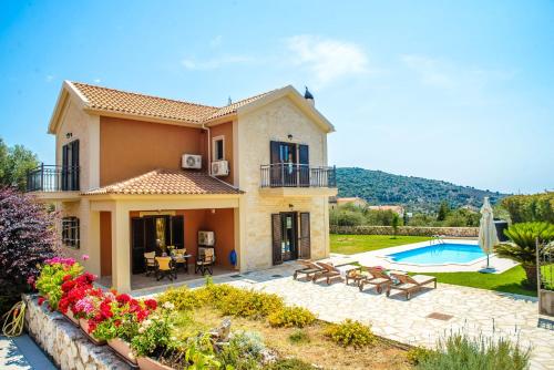 a villa with a swimming pool and a house at Kefalos Villas in Razáta