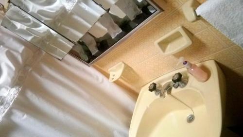 a bathroom with a sink and a mirror at Nomeolvides in Tandil