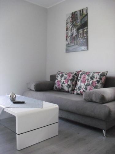 a living room with a couch and a coffee table at Apartments "Am Nationalpark" in Schwedt