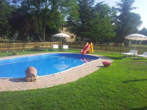 a swimming pool with a slide and a playground at Casa Giogo in Arezzo