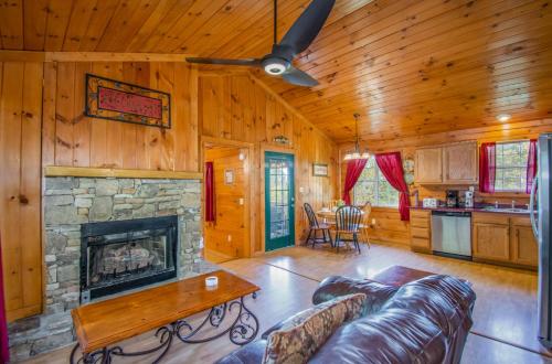 a living room with a fireplace and a couch at Ladybug Resort Romantic Cabin With Mountain Views, Game Room, Close to Dollywood in Sevierville