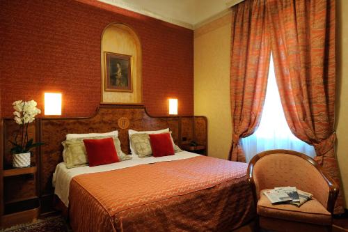 a hotel room with a bed and a window at Hotel Farnese in Rome