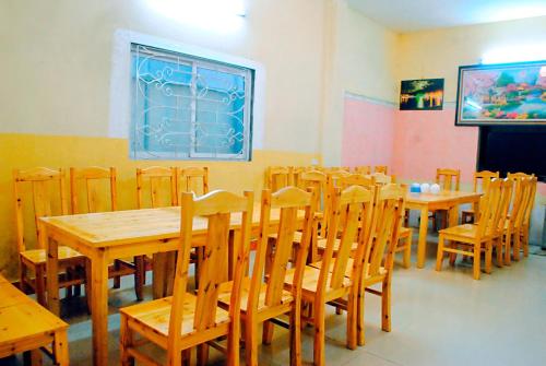 a dining room with wooden tables and chairs at Minh Anh Guesthouse in Sa Pa