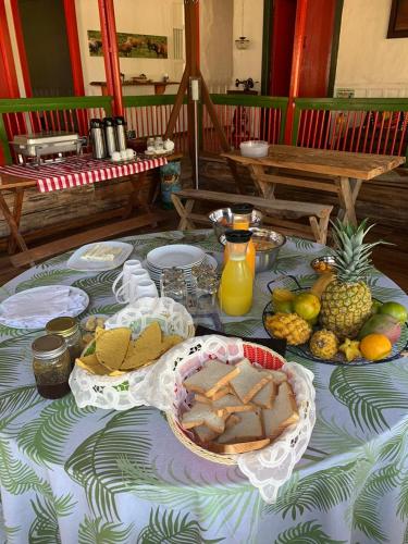 a table with a table cloth with food on it at Ecohotel Pinohermoso Reserva Natural in Salento