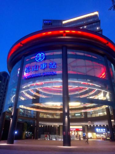 a building with a neon sign in front of it at Best Hotel in Taipei