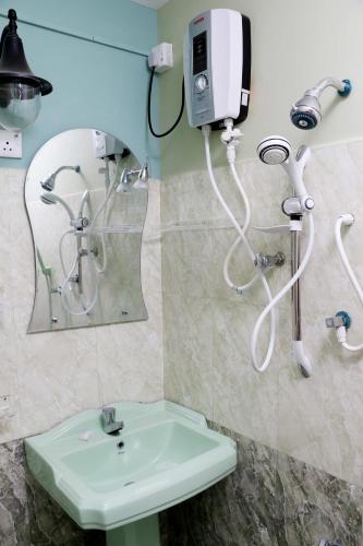 a bathroom with a sink and a mirror at The Cool Nest Yala Hotel in Tissamaharama