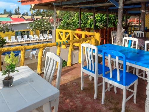 a blue and white table and chairs on a patio at Lanta Garden Home in Ko Lanta