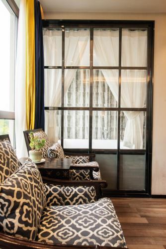 a living room with couches and a large window at Li River Resort Villa Hotel in Guilin