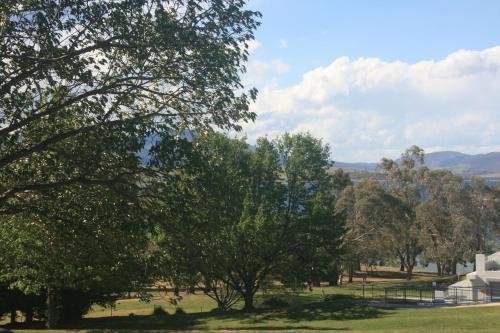 a view of a park with trees and a building at Jindy Inn in Jindabyne