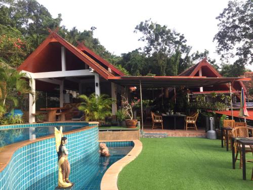a resort with a swimming pool and a restaurant at Krabi Villa Phu Khao Private Resort in Klong Muang Beach