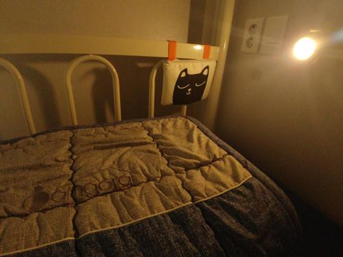 a bedroom with a bed with aooky face on it at Bomgoro Guesthouse in Daegu