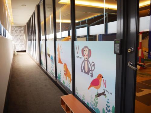 a hallway of a classroom with posters on the walls at Dubai Villa Motel in Daya