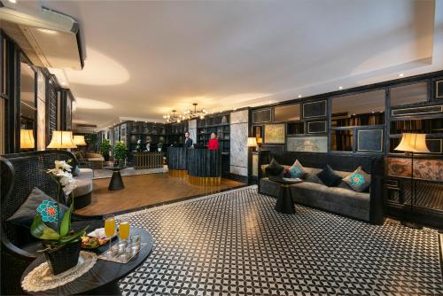 a lobby of a hotel with a couch and a table at Shining Central Hotel & Spa in Hanoi