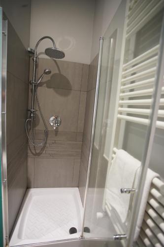 a shower with a glass door in a bathroom at La Dimora in Catania