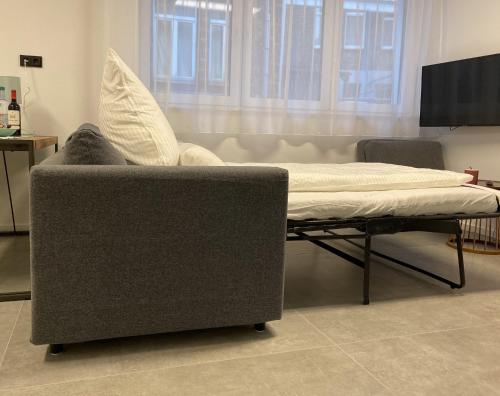 a couch and a bed in a living room at City Apartments Hannover in Hannover