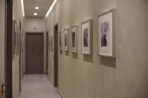 a hallway with a row of pictures on the wall at La Dimora in Catania