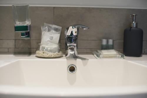 a bathroom sink with a faucet on a counter at La Dimora in Catania