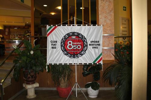 a sign hanging in a building with plants at Hotel Ismaele in Chiusi