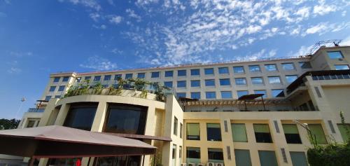 a large white building with plants on top of it at Ramada Neemrana in Neemrana