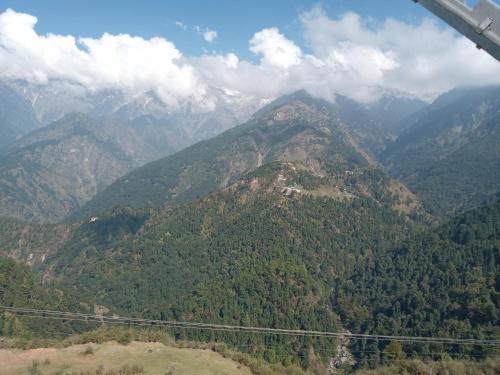 a view of a mountain range from an airplane at Dragon I Resorts in McLeod Ganj