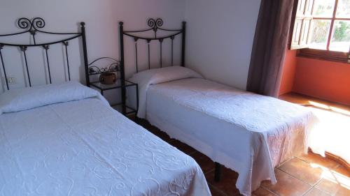 1 dormitorio con 2 camas individuales y ventana en TIAROSALIA, en Tijarafe