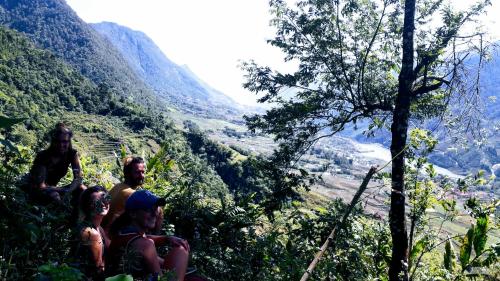 a group of people sitting on the side of a mountain at Surelee Homestay in Sa Pa