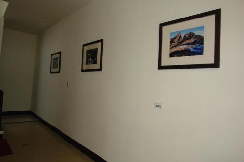 a room with three framed pictures on a wall at Hualien Sheraton Hostel in Hualien City