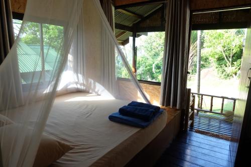 a bed in a room with a window at Lucky Resort in Haad Yao