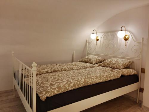 a bedroom with a white bed with two pillows at Danube Elegance Apartment in Budapest
