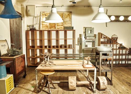 a room with a table and two pendant lights at Apartment Hotel Shinjuku in Tokyo