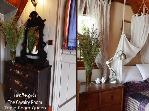 a bedroom with a bed and a dresser with a mirror at TwoAngels in Knysna