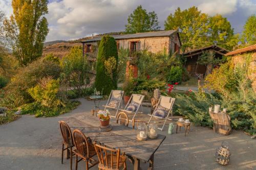 a wooden table and chairs in a yard at La Borda del Feu in Guardia de Arés