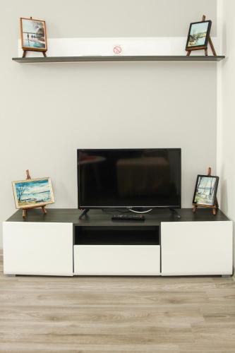 a white entertainment center with a flat screen tv at Apartmani Bojana in Vrdnik